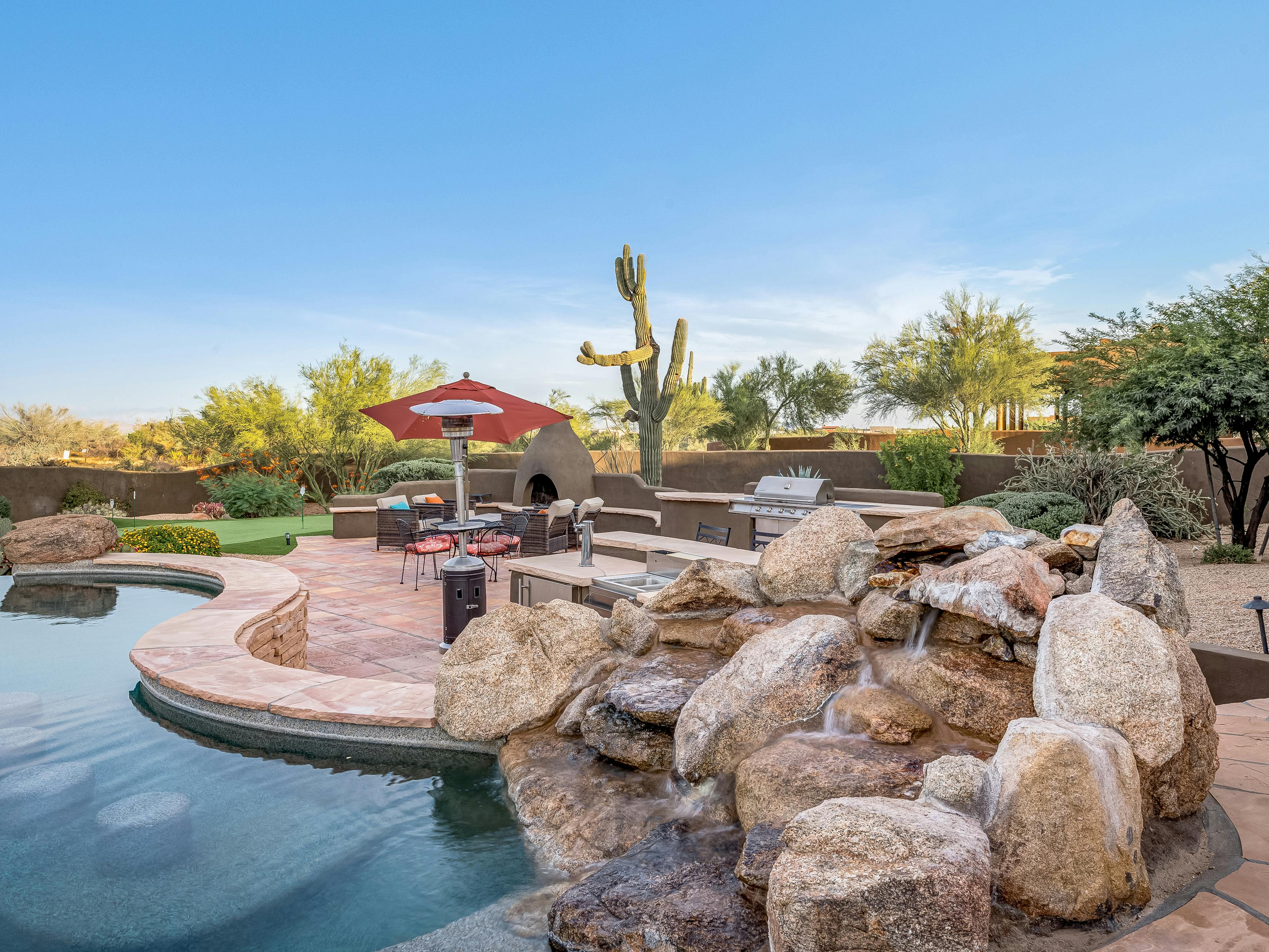 backyard of scottsdale, az vacation home with infinity pool and desert landscaping